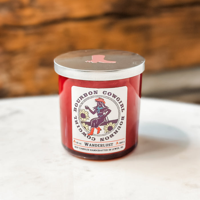 Red candle with silver lid and Bourbon Cowgirl label.
