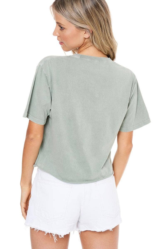 Woman in green shirt and white shorts.