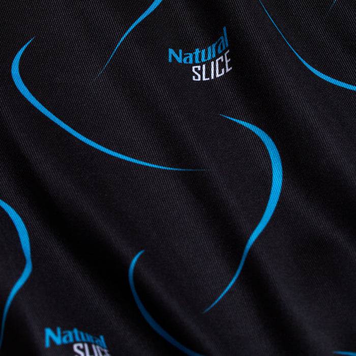 Close-up of the Natural Slice - Polo: black fabric with light blue curved lines and “Natural SLICE” printed in blue/white. The subtly textured material offers moisture wicking for comfort during any activity.