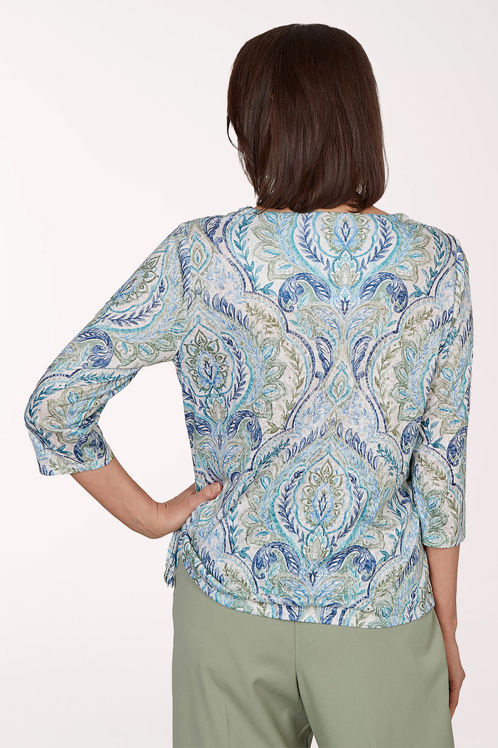 Woman wearing a blue paisley 3/4 sleeve top