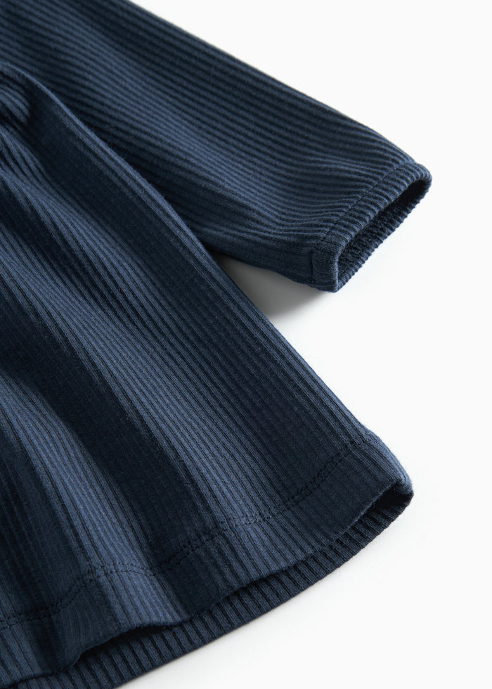 Dark blue ribbed dress for children with ruffle details and long sleeves