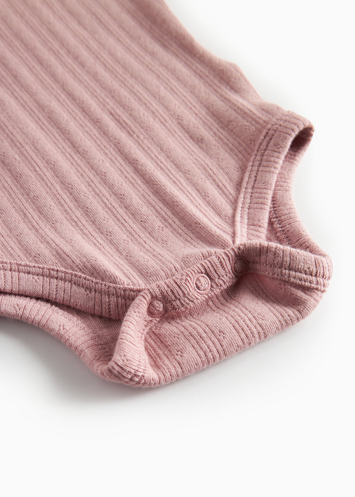 Pink pointelle bodysuit for children with long sleeves