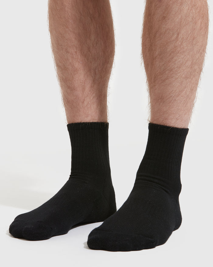 Black Half Crew Socks 6-Pack on feet, showcasing seamless toe seam.