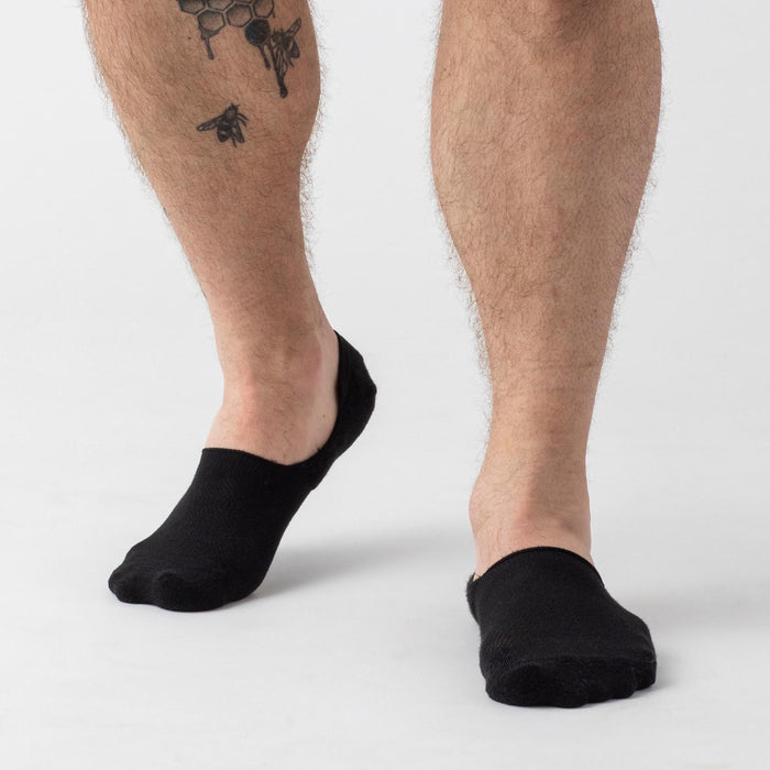 Black Never Show Socks 6-Pack on tattooed and bare lower legs.