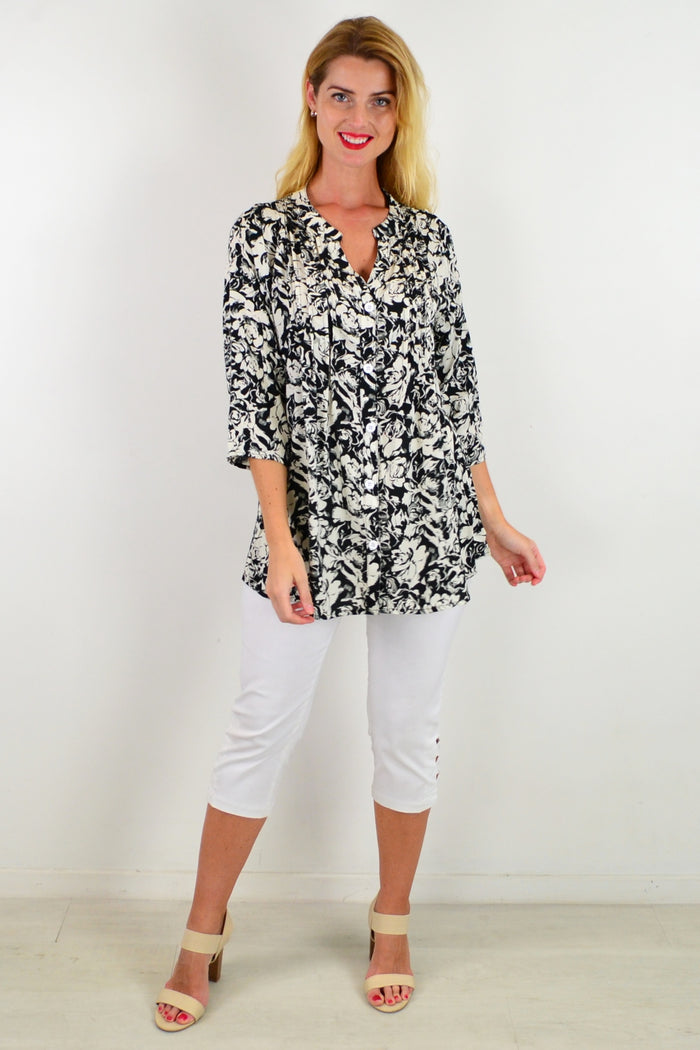 Black Roxanne floral tunic shirt by I Love Tunics, featuring a relaxed fit with vibrant floral pattern and button details.