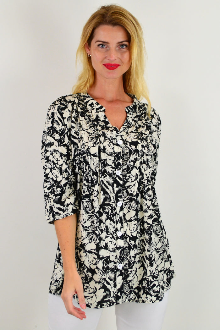 Black Roxanne floral tunic shirt from I Love Tunics, featuring a flowy silhouette and vibrant floral pattern.