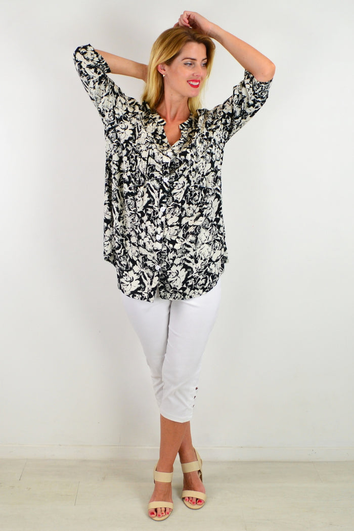 Black Roxanne floral tunic shirt by I Love Tunics, showcasing a flowy fabric and vibrant floral pattern.