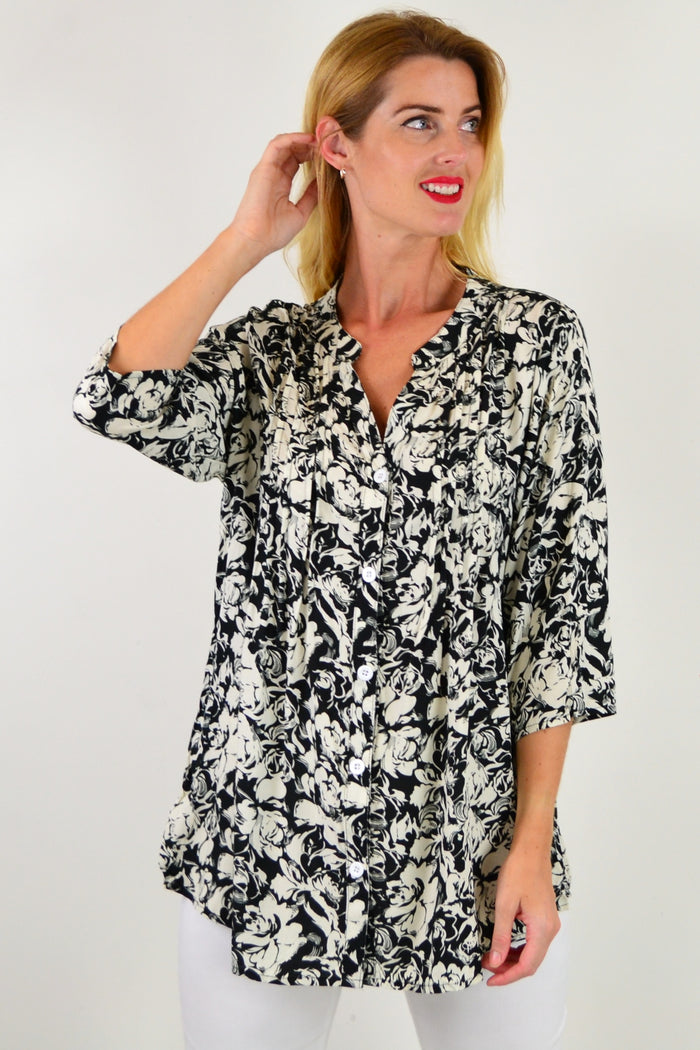 Black Roxanne floral tunic shirt from I Love Tunics, featuring a flowy silhouette and vibrant floral pattern.