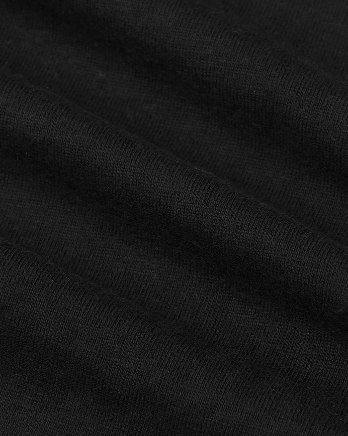Black Short Sleeve Tall Polo in soft knit fabric close-up showing fine jersey weave.