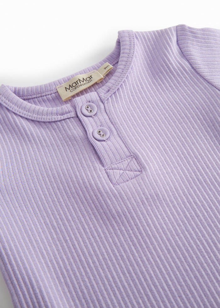 Short-sleeved baby modal bodystocking with peekaboo closure in a light purple shade.