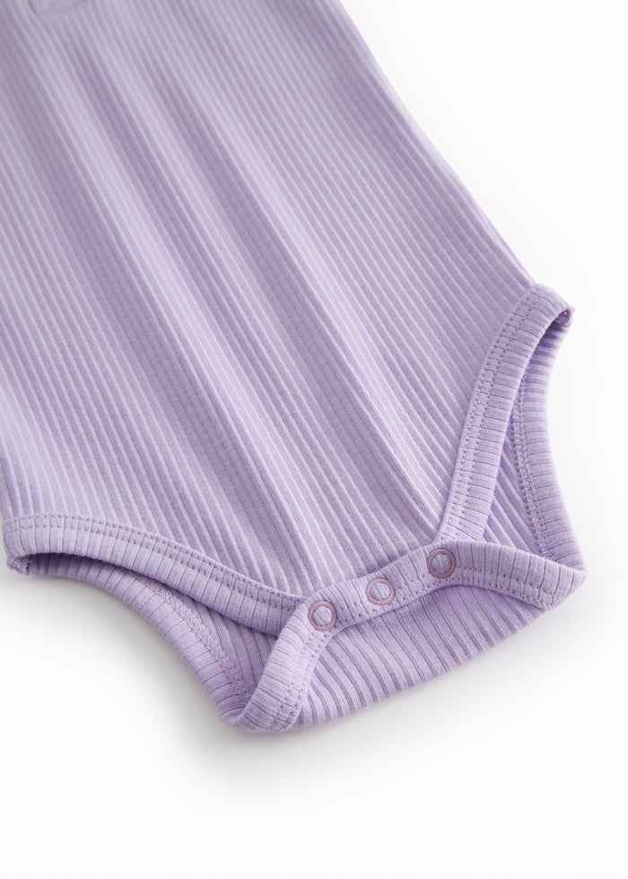Short-sleeved baby modal bodystocking with peekaboo closure in a light purple shade.