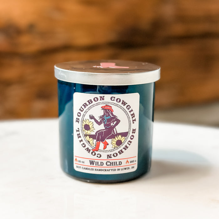 Blue candle with Bourbon Cowgirl label.
