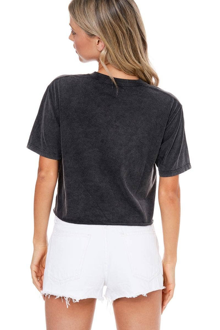 Woman wearing a black t-shirt and white shorts.