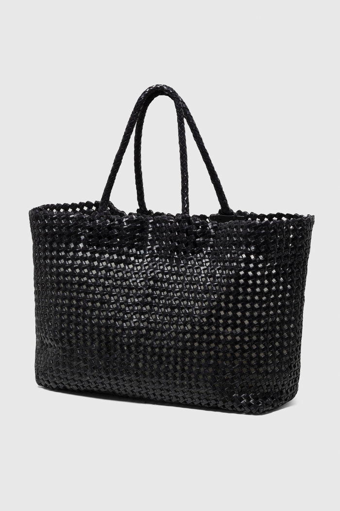 Brava Tote in Woven Leather With Top Handles and Spacious Interior in Black Colorway - angeled view off model