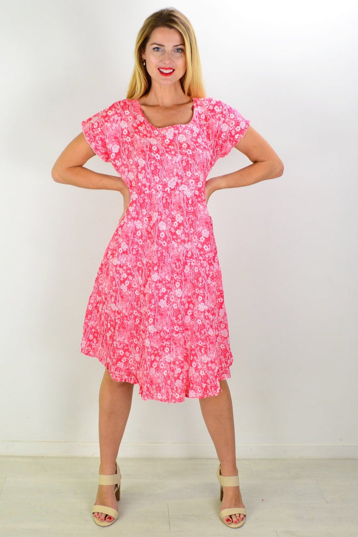 Orientique Cappadocia tiered boho tunic dress with flowy fabric, intricate patterns, and relaxed fit, displayed on a hanger.