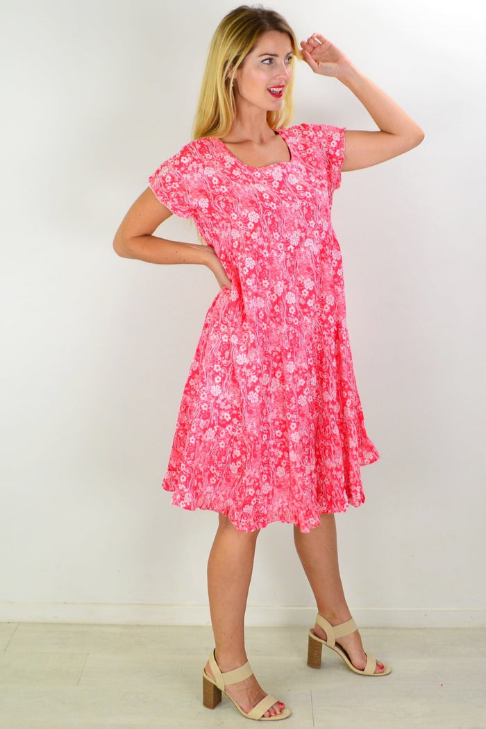 Orientique Cappadocia tiered boho tunic dress with colorful patterns and flowing fabric, shown on a hanger.