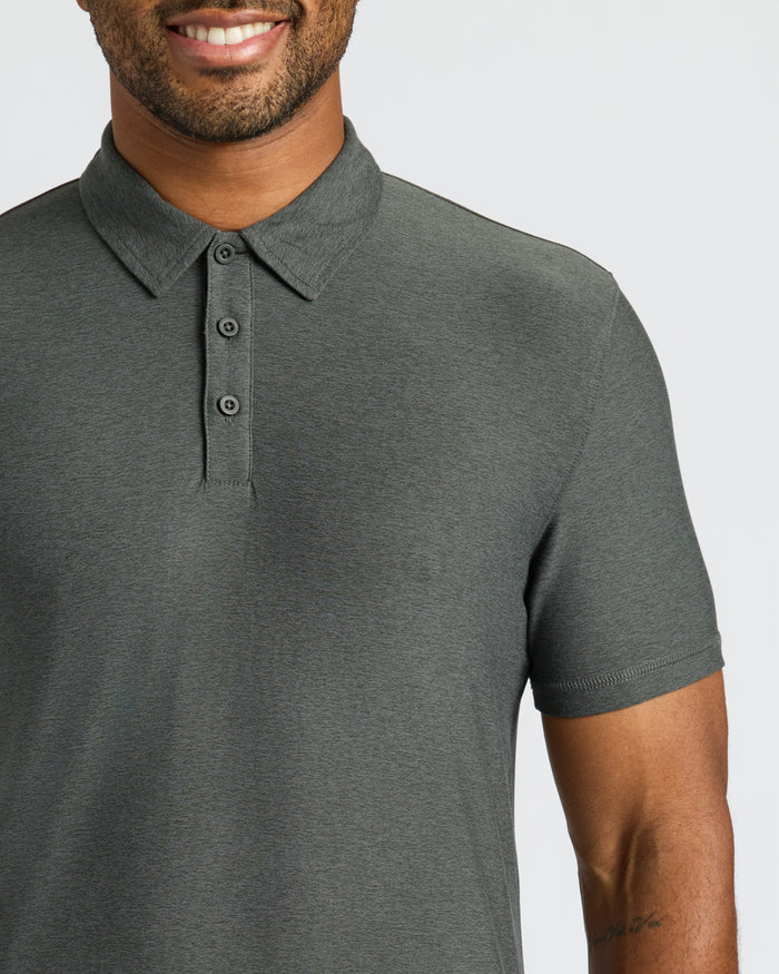 Man wearing Charcoal Heather Gray Classic Polo with a tattooed forearm visible.