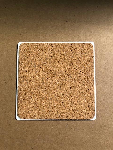 Square cork coaster with white border.