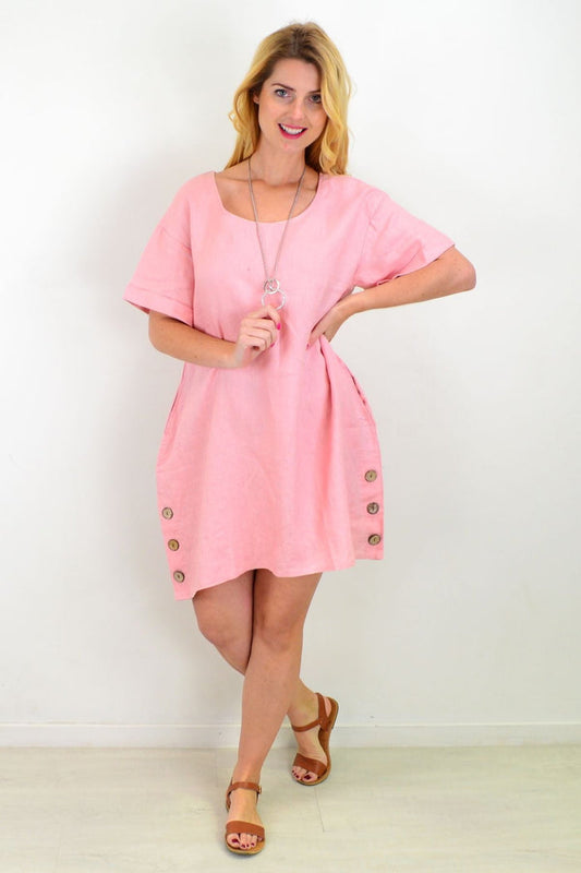 Dusty pink linen tunic dress by Cali&Co, featuring a relaxed shift design and natural fabric, displayed on a hanger.