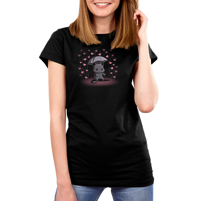 Premium Cotton T-shirt_TeeTurtle black Feeling Forecast Nope Premium Cotton T-shirt featuring a cat frowning and holding an umbrella, in the background there is pink rain with hearts.