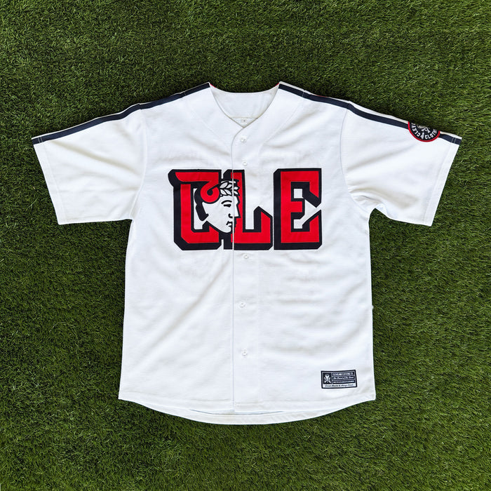White baseball jersey with red and black design on a green grass background