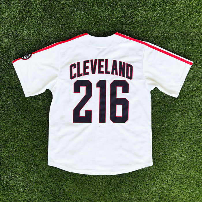 Baseball jersey with 'Cleveland 216' on a grass field