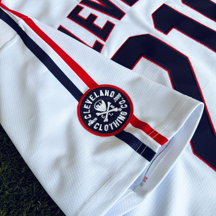 Close-up of a sports jersey with a logo on a grass background