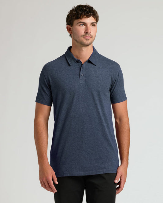 Man wearing a blue polo shirt against a gray background