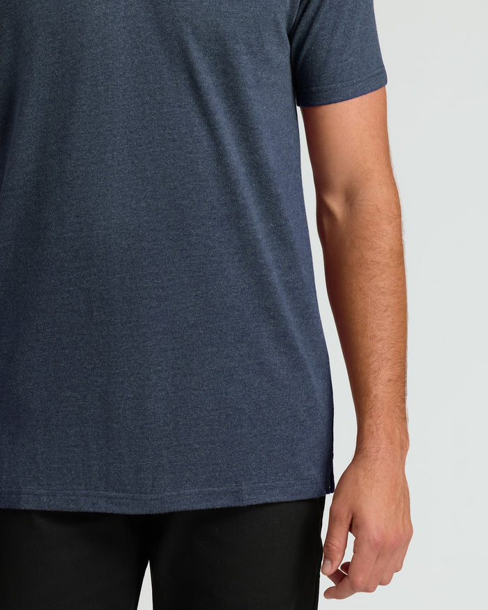 Heather Navy Short Sleeve Tall Polo on person wearing black pants.