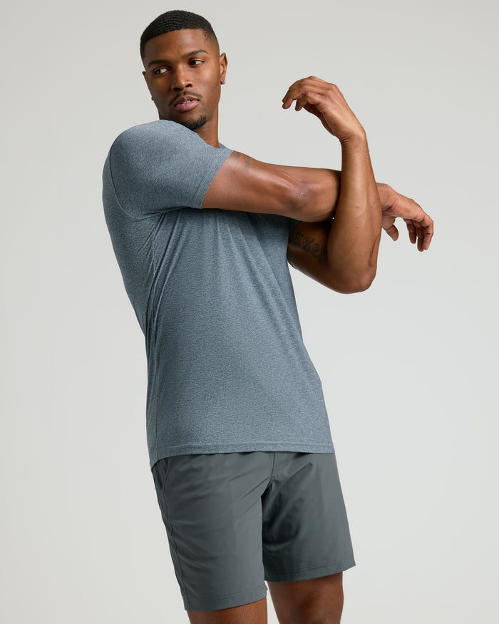 Man stretching in Heather Navy Tall Active Crew Neck 2.0.