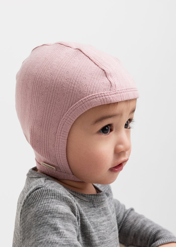 Children wearing pink pointelle helmets