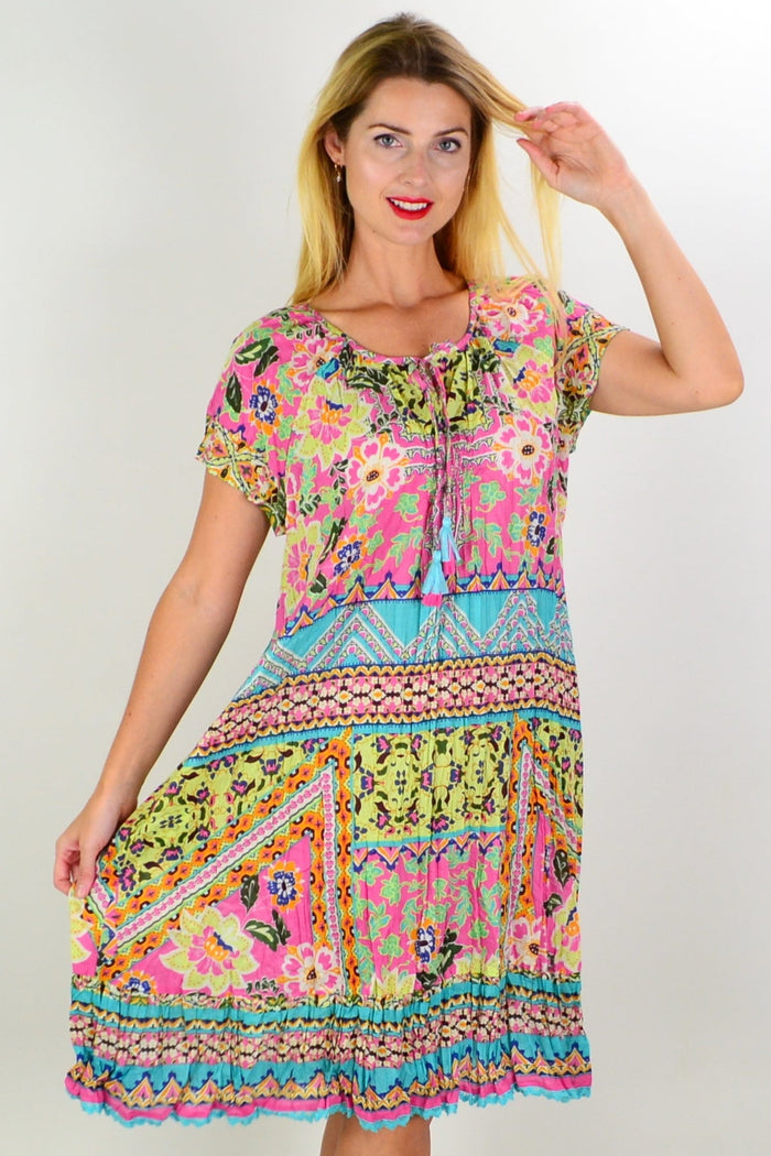 Iruya Crinkle Tie Neck Tunic Dress by Orientique featuring a relaxed fit, crinkle fabric, and tie-neck detail.