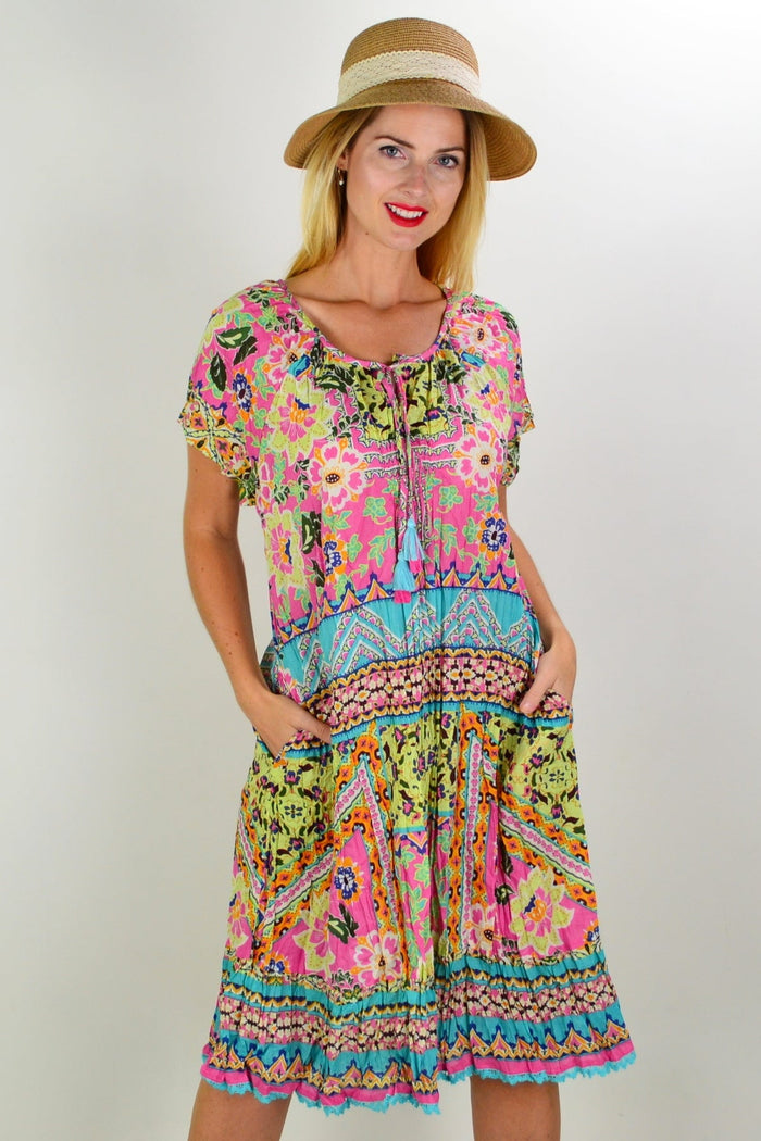 Orientique Iruya Crinkle Tie Neck Tunic Dress hanging on a mannequin, showcasing its relaxed fit and crinkle fabric detail.