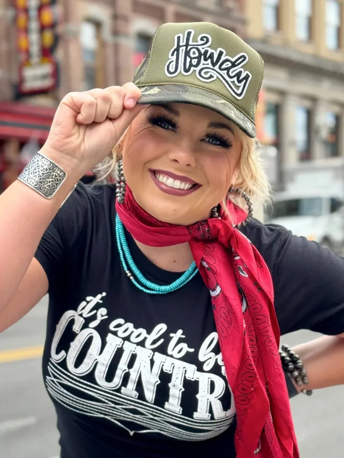 Woman wearing Howdy hat and It's cool to be Country shirt