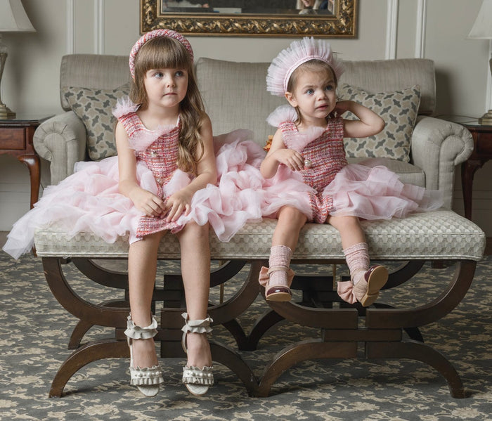 Kellie Crown Hair Sash worn by toddler in blush pink pleated tulle crown style, paired with matching pink tweed and layered tulle dress for luxury girls occasion wear.