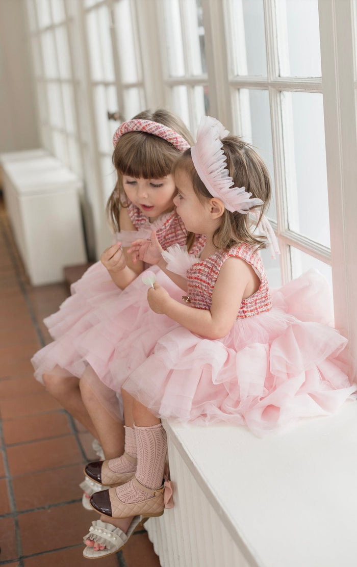 Side view of Kellie Crown Hair Sash showcasing soft blush pleated tulle crown silhouette styled with pink layered tulle dress – boutique girls birthday and wedding accessory.