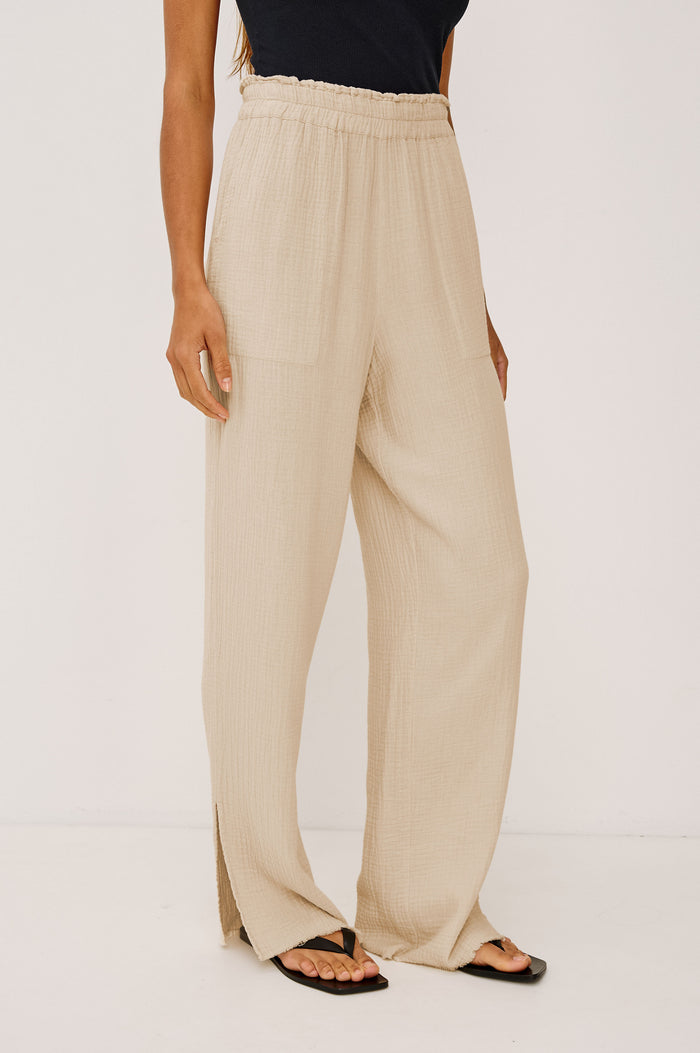 Leon Cotton Gauze Pant With Hemline Slit And Elastic Waist In Colorway Flax - Front View Featured On Model
