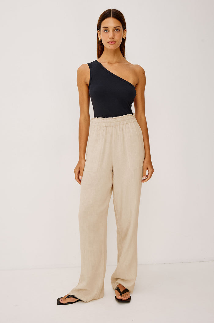 Leon Cotton Gauze Pant With Hemline Slit And Elastic Waist In Colorway Flax - Full Front Body View Featured On Model
