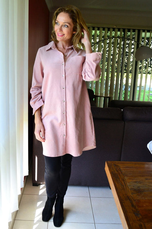 Long pink corduroy tunic shirt dress by Hourglass, featuring a relaxed fit with a collar and button-front detail.