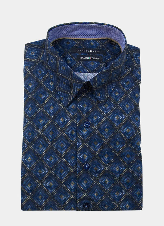 The Mosaic is a folded long-sleeve button-up shirt featuring a blue geometric diamond pattern, with an “Italian Fabric” label inside the collar.