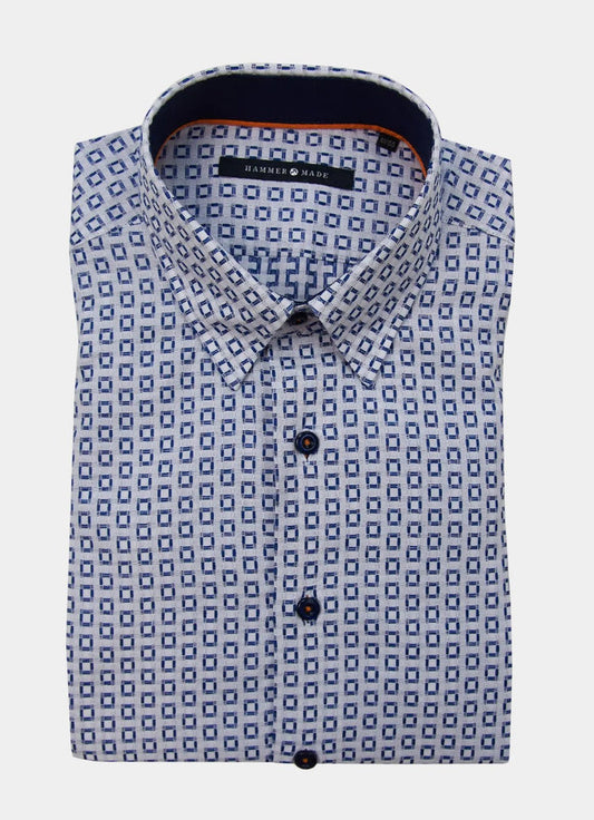 The Ogilvie men's dress shirt features long sleeves, a blue geometric square pattern, and dark buttons, neatly folded.