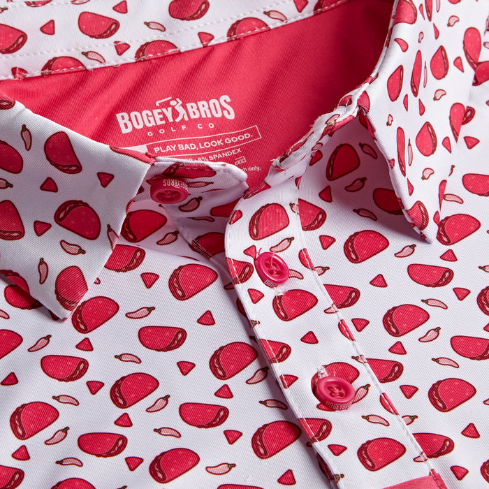 Close-up of the Pink Taco - Polo: a white collared shirt with pink buttons, red and pink cartoon steak pattern, athletic fit, and a BOGEY BROS tag with extra text on a pink background inside the collar.