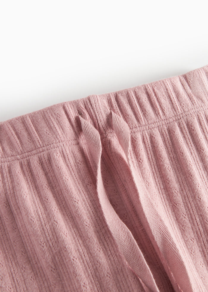Pink pointelle trousers for children with ties and ribbed edges