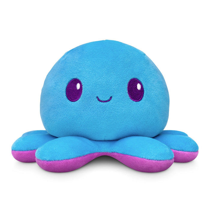 Introducing the TeeTurtle Plushiverse Indigo Octo 4" Reversible Plushie: a blue octopus stuffed toy with a smiling face and purple tentacle undersides.