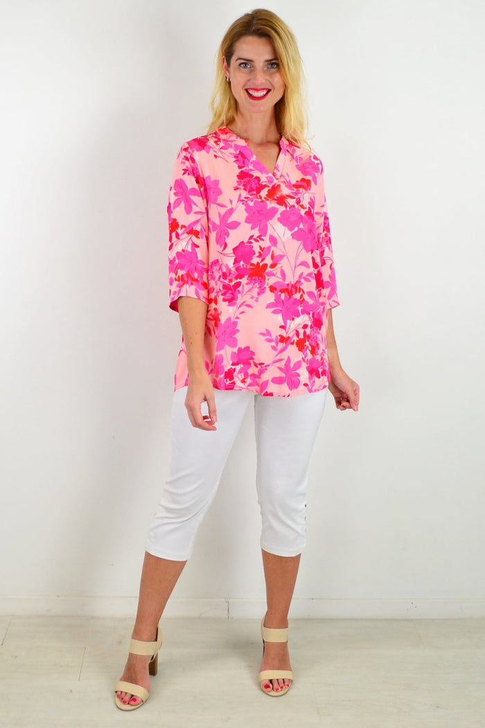 Floral tunic top by I Love Tunics featuring vibrant colors, lightweight fabric, and a relaxed fit with a round neckline.