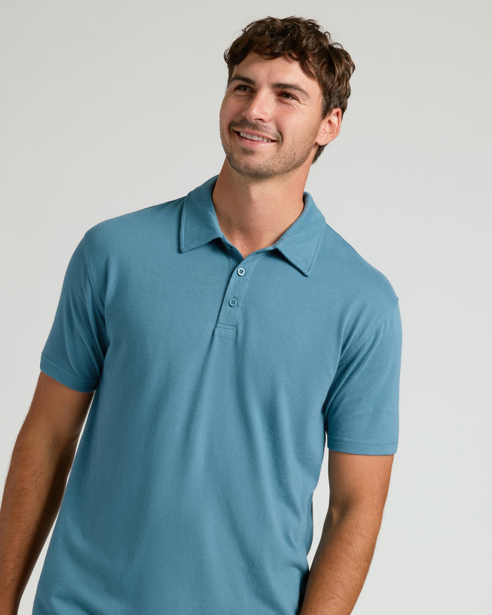 Sapphire Short Sleeve Tall Polo on smiling man with wavy hair.