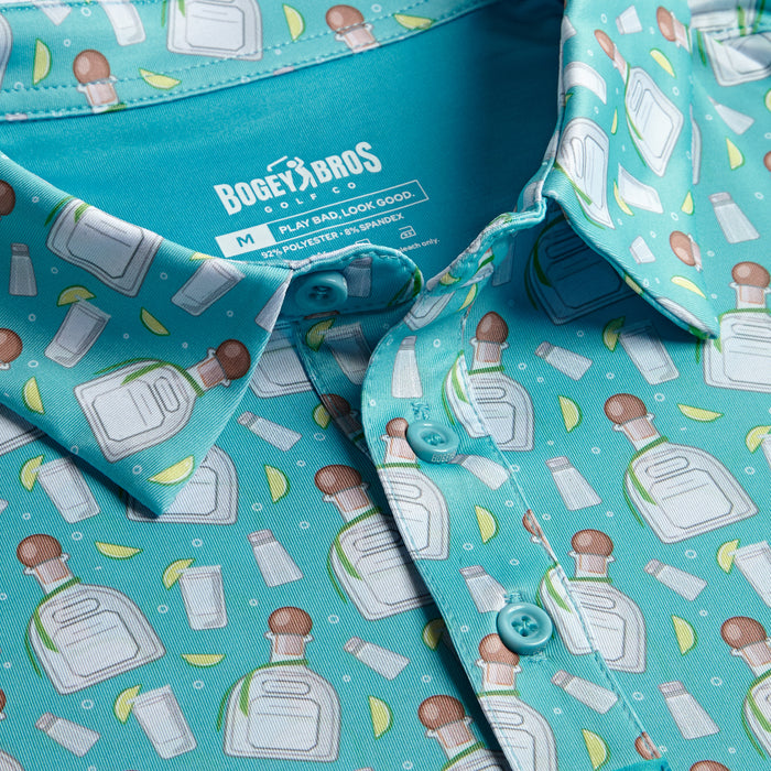 A close-up of the Bogey Bros Tequila - Polo, size M: a turquoise athletic fit shirt with illustrated tequila bottles, limes, salt shakers, white buttons, a bright blue inner collar, and UPF 50 protection.