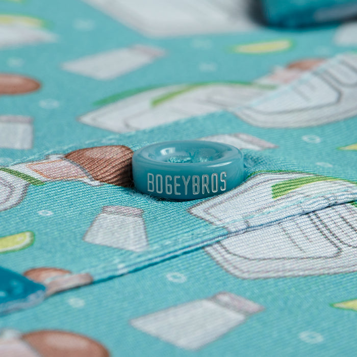 Close-up of the Tequila - Polo, featuring themed salt shaker and lime illustrations. The athletic fit shows the blue BOGEYBROS button, with visible fabric texture and vibrant print details.