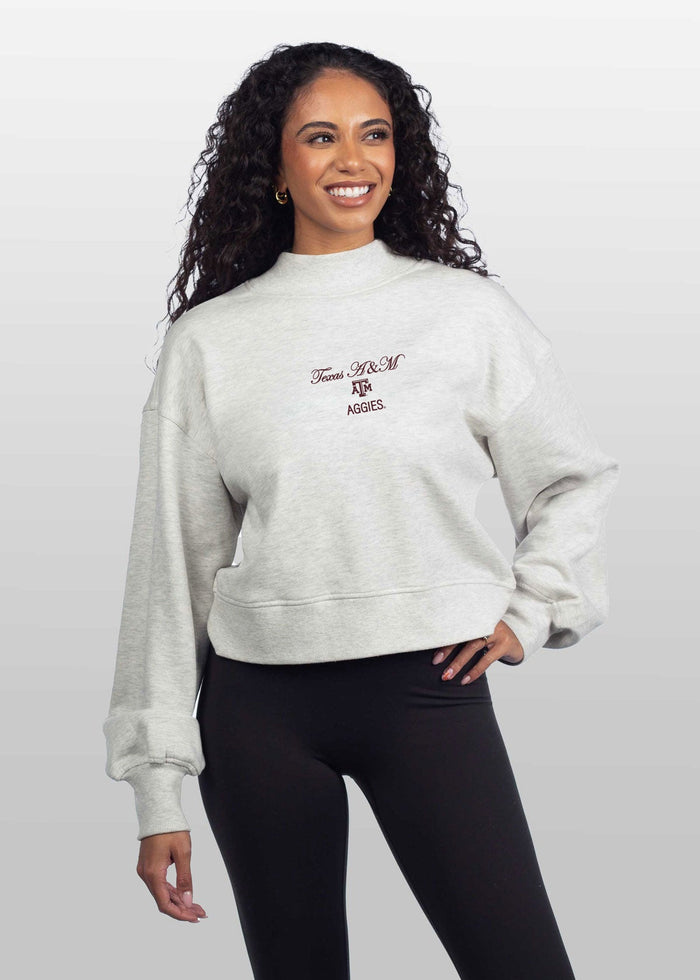 Texas A&M Aggies Women's Ash-Grey Relaxed, waist-length Heavyweight Fleece Sweatshirt with mock neck, drop shoulders and balloon sleeves