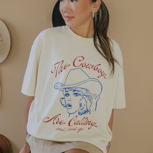 Woman wearing a t-shirt that says The Cowboys Are Calling